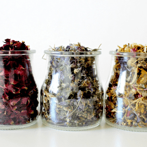 Image of dried herbs ready for cooking in glass jars.