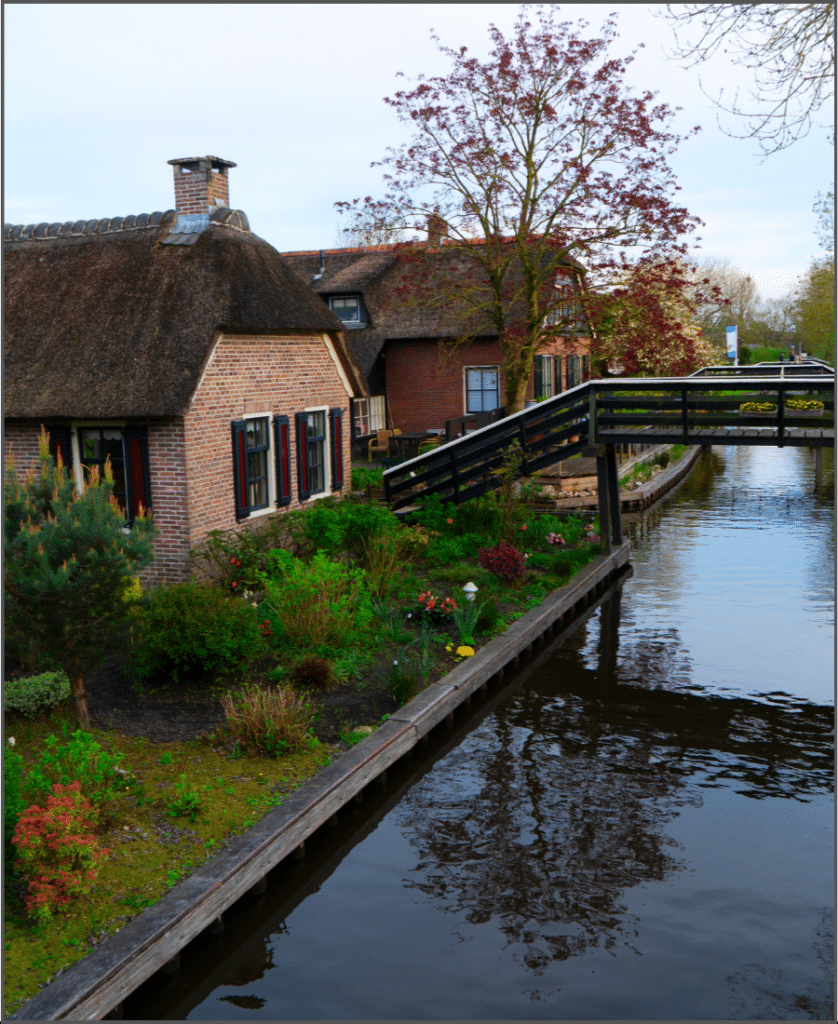 house beside a canal with bridge