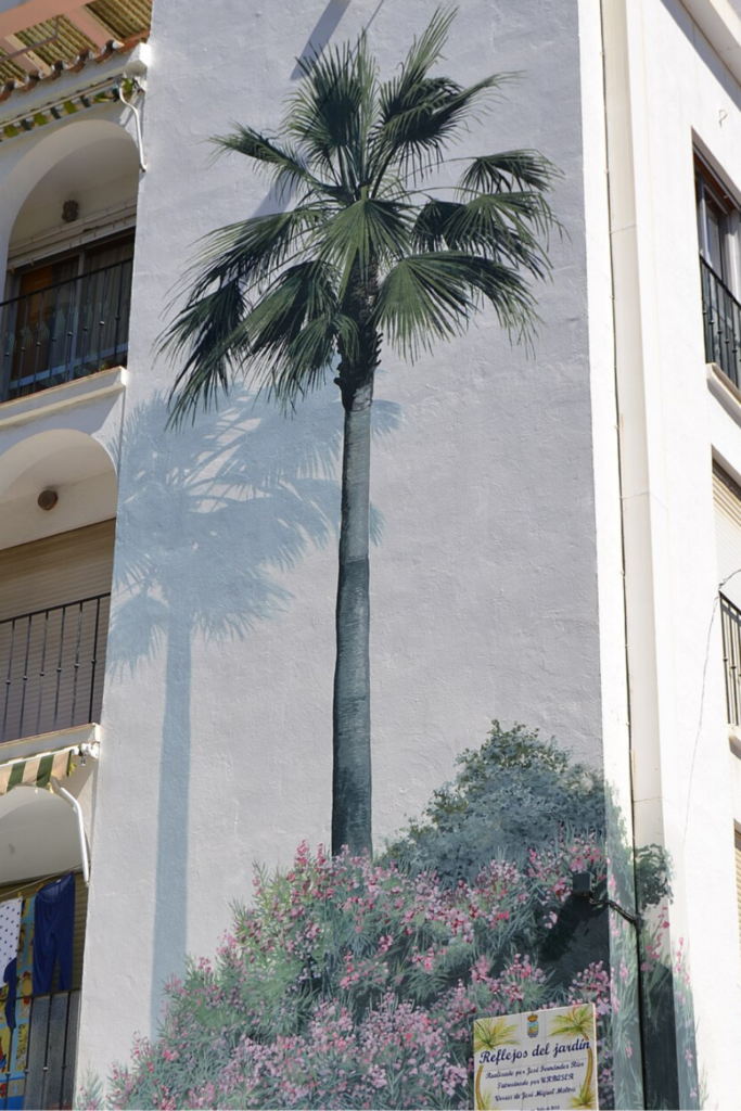 a mural of a multi story palm tree, in Estepona Spain