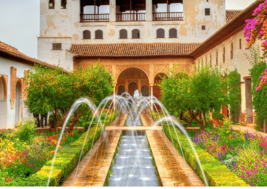 “Small courtyard fountain surrounded by greenery, with soft water flow and shaded garden walls.”