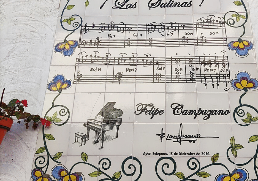 Ceramic tile mural with music and floral images and surrounded by planters