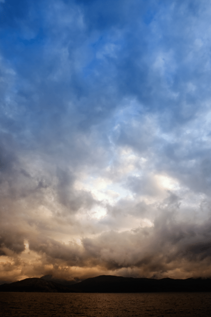 Dark June storm clouds forming over a Florida landscape, illustrating early summer storm season and garden preparation needs.
