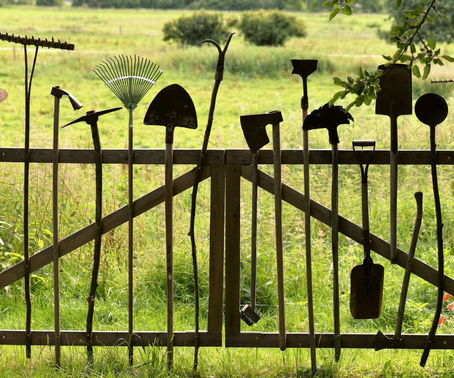 A gate to a farm or garden made by incorporating tools