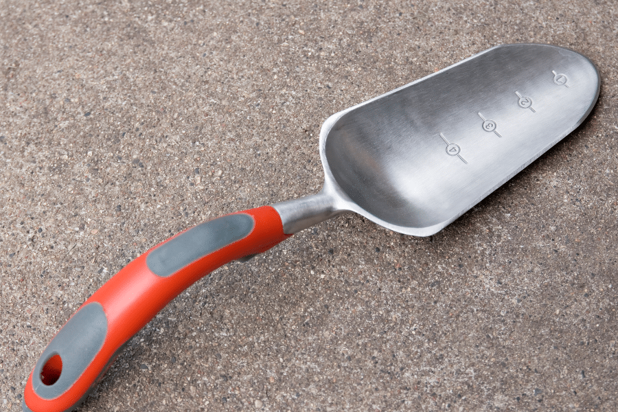Ergonomic garden trowel with a bent, soft‑grip handle that supports natural wrist alignment while digging.
